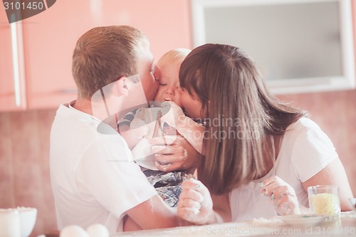 Image of Happy smiling family at kitchen