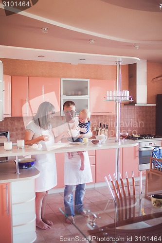 Image of Happy family cooking at kitchen