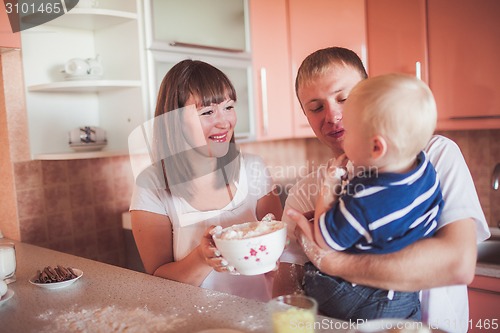 Image of Happy family cooking at kitchen
