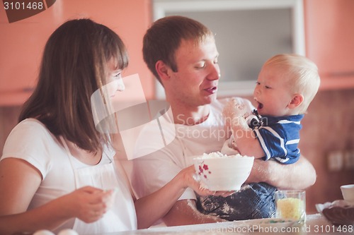 Image of Happy family cooking at kitchen