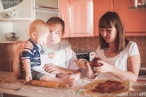 Image of Happy family cooking at kitchen