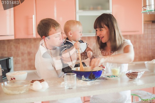 Image of Happy family cooking at kitchen