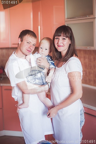 Image of Happy smiling family at kitchen