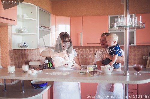 Image of Happy family cooking at kitchen