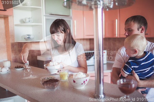 Image of Happy family cooking at kitchen