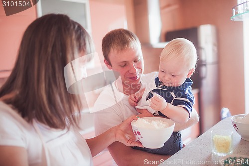 Image of Happy family cooking at kitchen