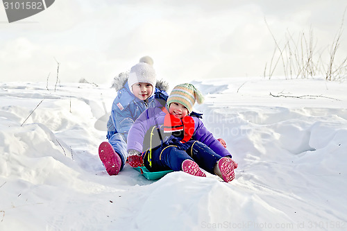 Image of Two girls on sled in winter