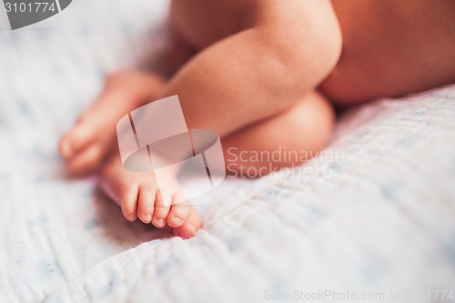 Image of Baby feet on white blanket