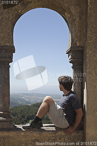 Image of Young man in arabian arch of  Pena palace, Sintra