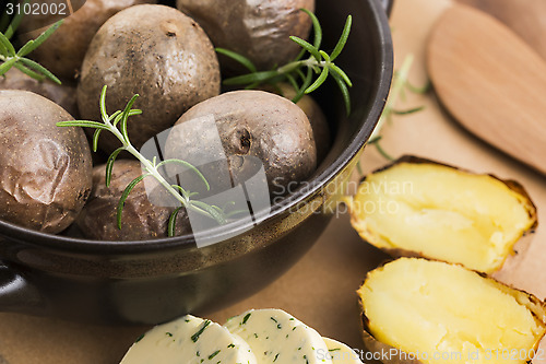 Image of  baked potatoes with herbs butter