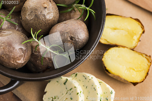 Image of  baked potatoes with herbs butter