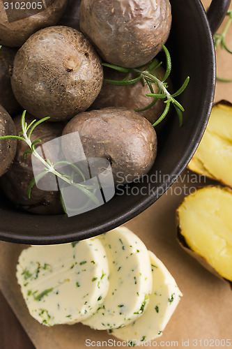 Image of  baked potatoes with herbs butter