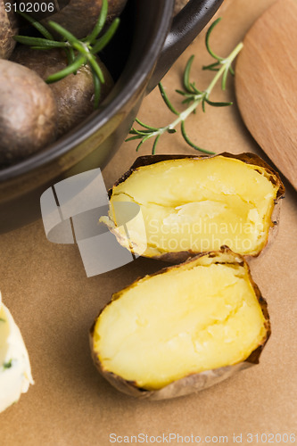 Image of  baked potatoes with herbs butter