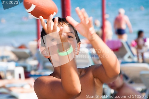 Image of  The boy plays with a ball