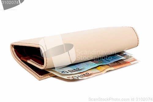 Image of Monetary denominations lie in a wallet on a white background