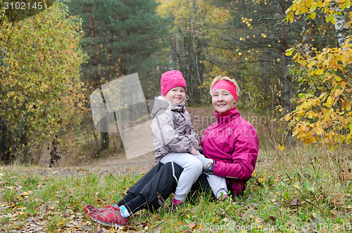 Image of Grandmother with her granddaughter in the autumn park