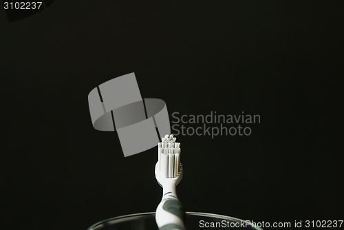 Image of toothbrush on a glas