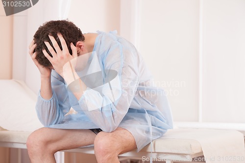 Image of male patient sitting in hospital 