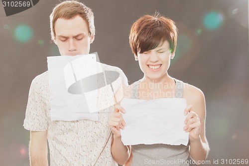 Image of Young Beautiful Couple Holding Cardboard 