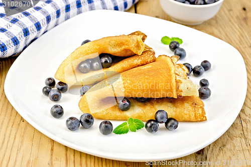 Image of Pancakes with blueberries on wooden board