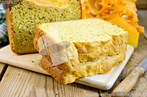 Image of Bread pumpkin homemade with knife on wooden board