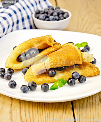 Image of Pancakes with blueberries on board