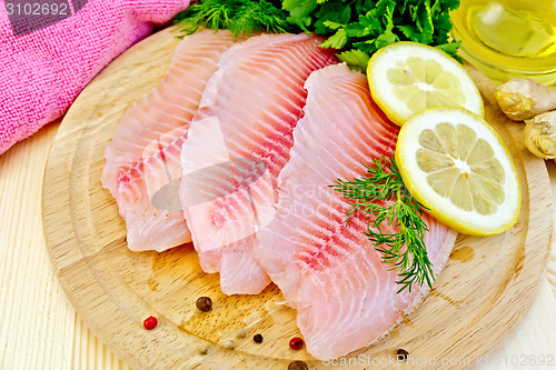 Image of Tilapia with oil and lemon on light board