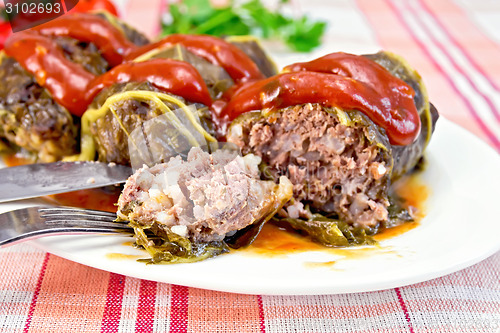 Image of Rhubarb leaves stuffed with fork in plate on tissue