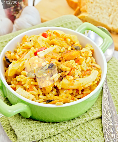Image of Pilaf with seafood and bread on napkin