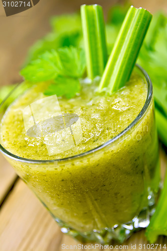 Image of Cocktail with celery stalks in glassful on board