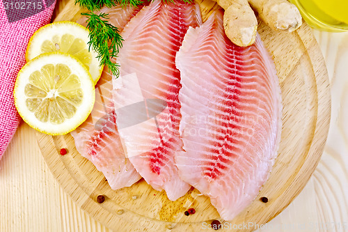 Image of Tilapia with parsley and lemon on light board