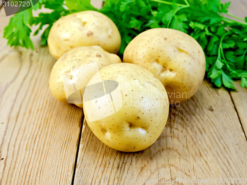 Image of Potatoes yellow with parsley on wooden board