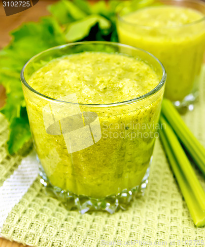 Image of Cocktail with celery on napkin and board