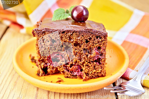 Image of Cake chocolate with cherries and napkin on board