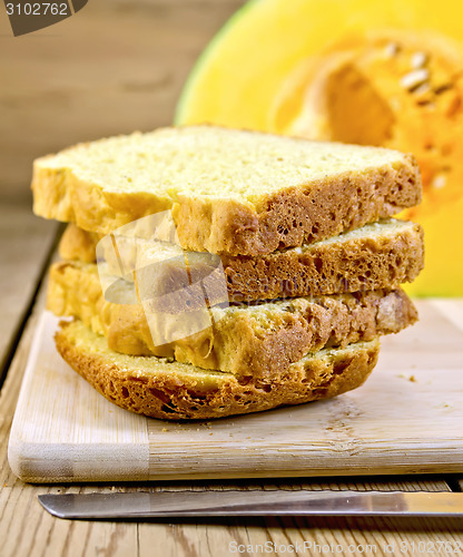 Image of Bread pumpkin homemade slices with knife on board