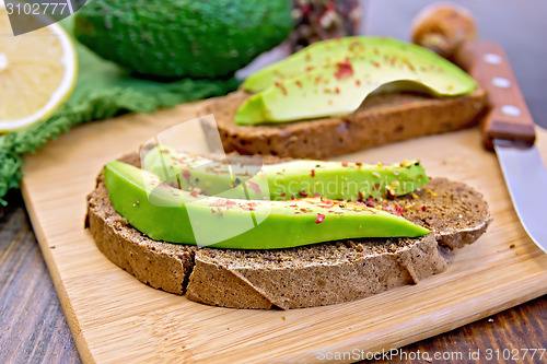 Image of Sandwich with avocado and pepper on board