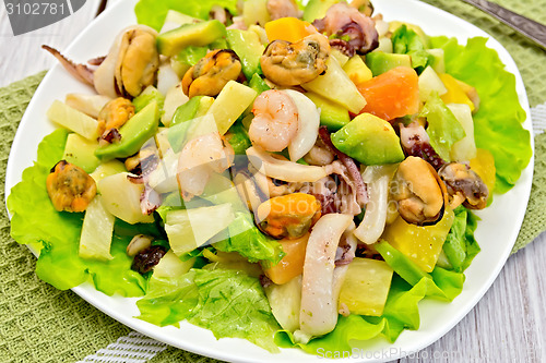Image of Salad seafood and avocado on light green napkin