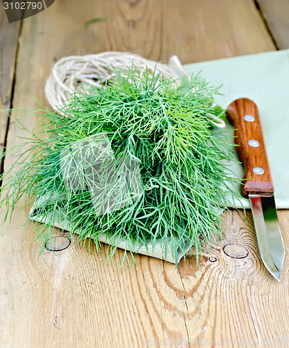Image of Dill green with knife and napkin on board