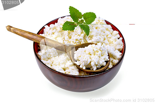 Image of Curd in wooden bowl with spoon