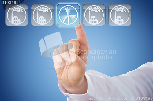 Image of Finger Pushing Wind Power Button Over Blue Ground