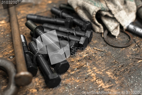 Image of Black bolts on grungy table