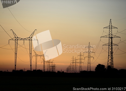 Image of Large transmission towers at sunset