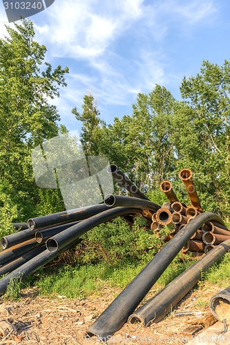 Image of Rusty metal pipes in the forest