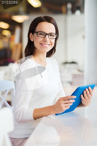 Image of smiling woman with tablet pc at cafe