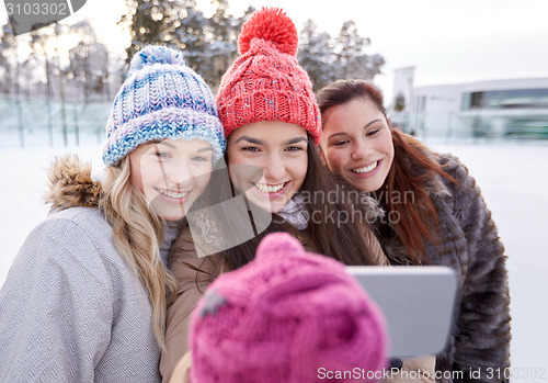Image of happy teenage girls taking selfie with smartphone