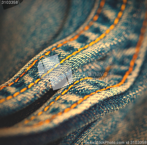 Image of Jeans with yellow stitching thread