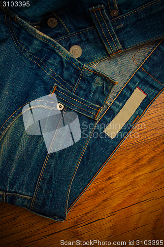 Image of old unbuttoned jeans