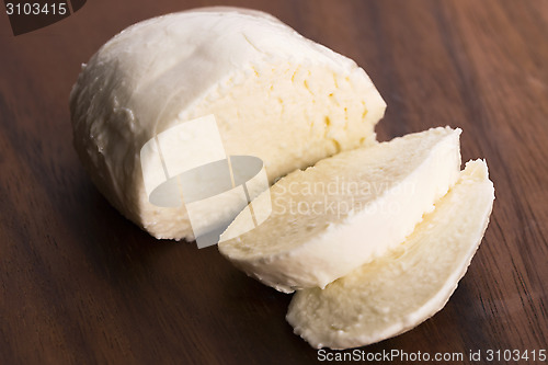 Image of Sliced mozzarella on wooden board 