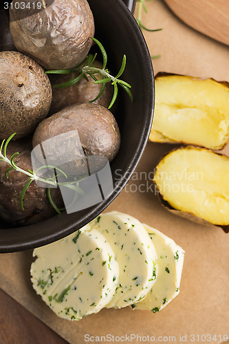 Image of  baked potatoes with herbs butter