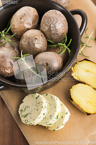 Image of  baked potatoes with herbs butter